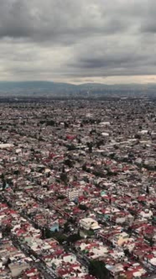 Vertical aerial drone footage of Mexico City during overcast conditions