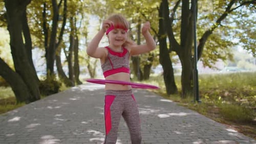 Athletic Fitness Children Girl Training Playing Twisting Hula Hoop Circle Ring Around Waist in Park