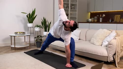 Man Practicing Yoga in Living Room