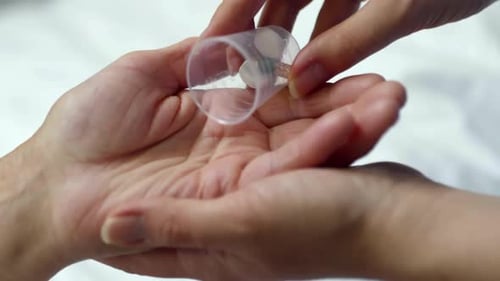 Hand eines unbekannten Patienten, der Medikamente einnimmt. Pillen und Medikamente in die Handfläche gießen