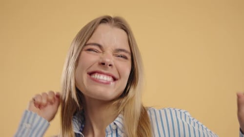 Happy Woman Dancing On Beige Studio Background Favorite Music Smiling Lady