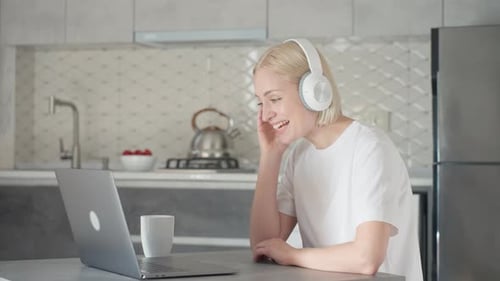 Woman Using Laptop for Video Call at Home