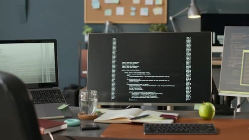 Computers with Running Codes on Screen in Modern Programmers Office