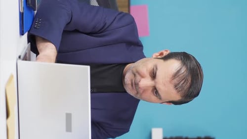 Adult Working at Desk Using Laptop