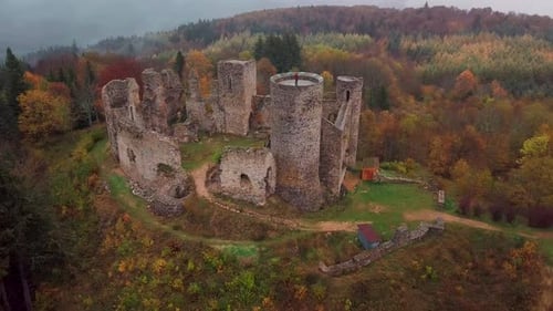 aerial shot around the Castle of the Cornes d'Urfé during fall on a foggy day in Champoly within the