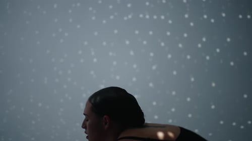 Beautiful Woman In Black Suit Dancing Passionate And Emotional Dance In Studio With White Walls