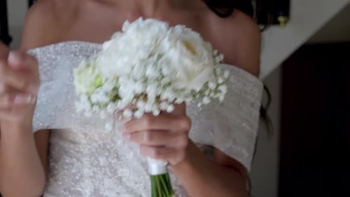 Bride Holding White Flower Bouquet in Dress