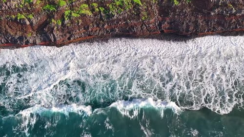 Ocean Waves Crashing on Rocky Coastline from Above