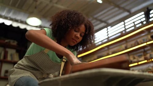 People Creating Pottery in Studio. Female artisan creating handmade ceramics in pottery workshop