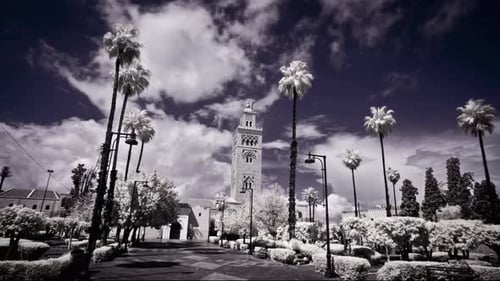 Speed ramped, wide shot time lapse of clouds sailing by the Koutoubia Mosque in Marrakech, Morocco.
