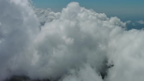 Flying Through White Clouds Over Sea