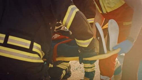 On the Car Crash Traffic Accident Scene: Rescue Team of Firefighters Pull Female Victim out of Roll