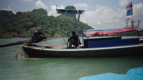 Thai Seaman Resting on a Wooden Moored Hopping Tour Travel Boat Enjoying the View of Railay Beach on