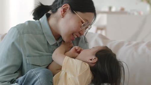 Mother and Child Interacting Affectionately on Couch