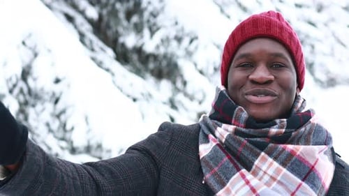 Smiling Man in Winter with Red Beanie and Scarf