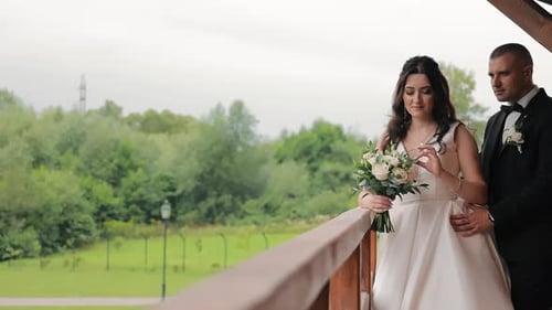 The Newlyweds are Walking in the Park on Their Wedding Day Beautiful Bride and Groom are Holding