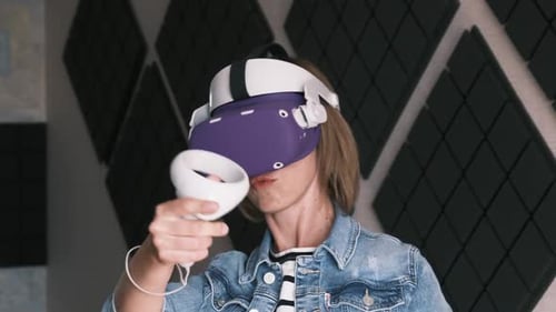 Woman Using VR Headset and Controllers Indoors