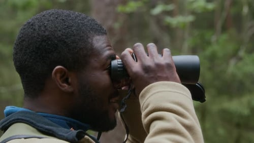 Man Birdwatching with Binoculars in Forest, Close Up