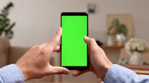 Man swiping left on green screen smartphone mockup for social media content