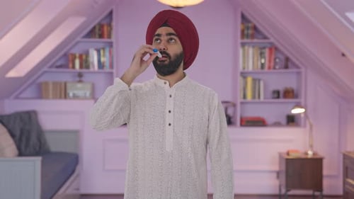 Man Checking Temperature with Thermometer in Bedroom