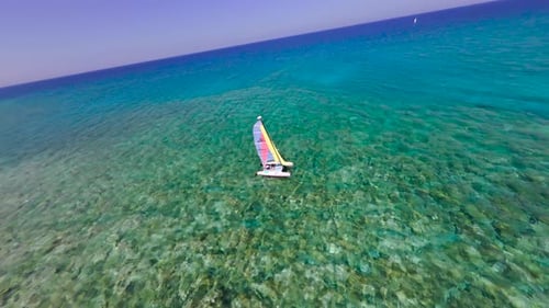 Sailing in clear blue waters on a sunny day in a beautiful coastal location