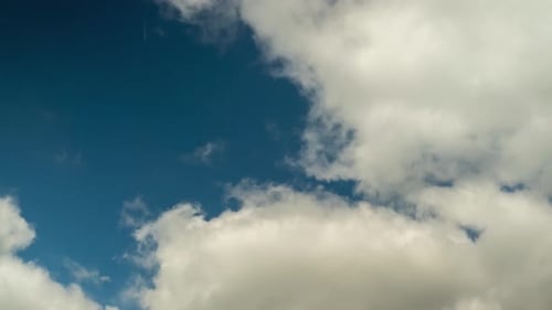 Clouds Moving Slowly Across a Blue Sky