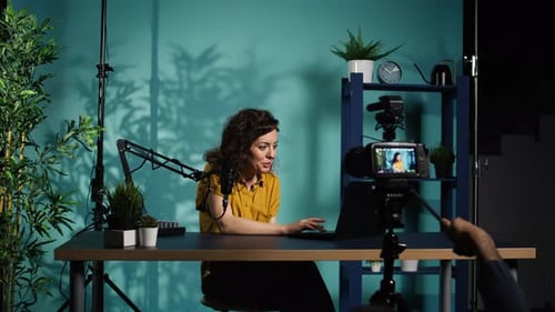 Woman Recording Video in Studio with Microphone