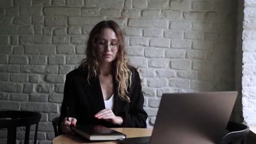Young Woman Working on Her Laptop Computer in Coffee Shop