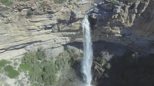 4k drone footage of a waterfall in a majestic mountain range