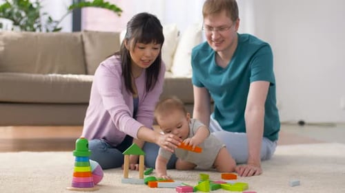 Family playing together with colorful wooden blocks at home
