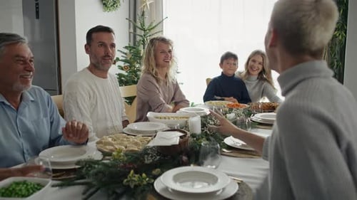 Family Gathered Around Table Laughing