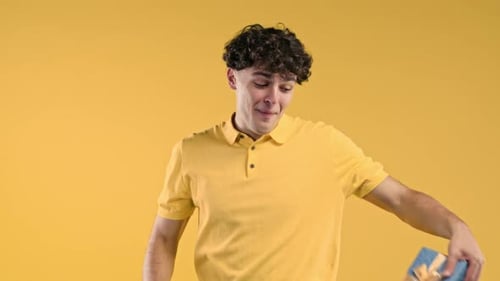 Young Adult Presents Wrapped Gift with Ribbon