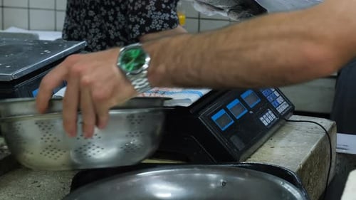 Seller Weighing Raw Fish at the Seafood Market