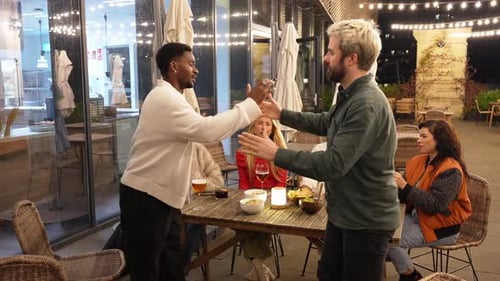 Friends Greeting Each Other at a Rooftop Bar