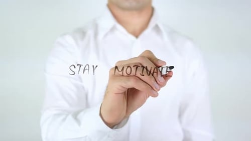Stay Motivated, Man Writing on Glass