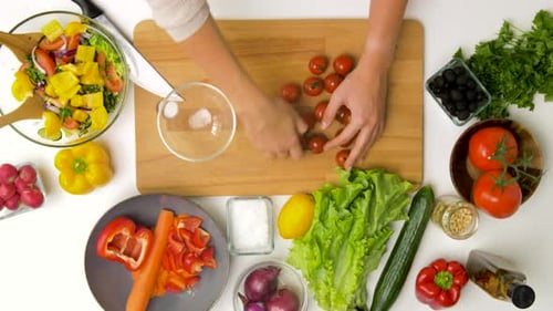 Preparing Colorful Salad with Fresh Vegetables in Kitchen
