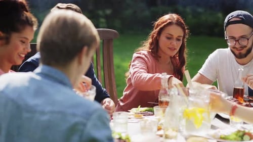 Group of friends sharing a meal at outdoor table