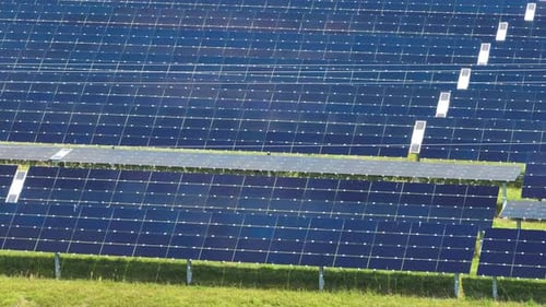 Aerial View of Big Sustainable Electric Power Plant with Many Rows of Solar Photovoltaic Panels for