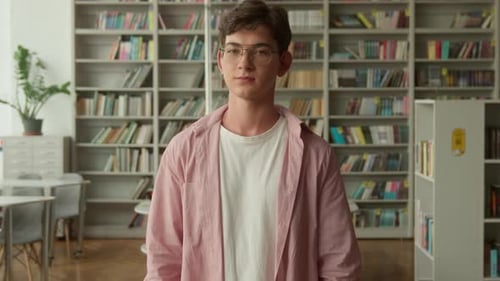 Caucasian Guy Student in Library Smiling Showing Thumb Up Like Gesture Recommend Teen in Books Store