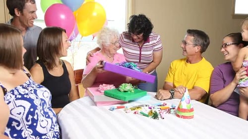 Family Gathering Around Table With Birthday Presents