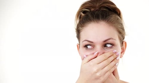Woman Covers Her Mouth on White Background