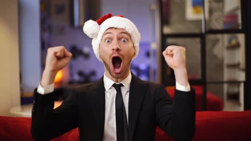 Man in Santa Hat Exclaims with Excitement