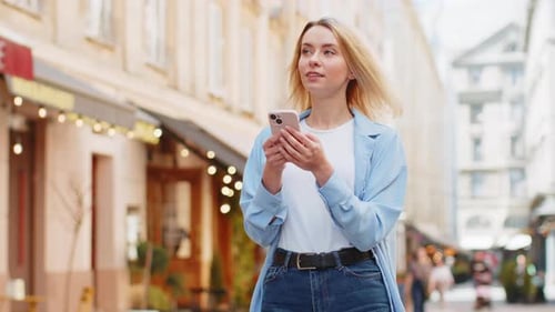 Happy Woman Using Smartphone Typing Texting Social Media Application Messages Email on City Street