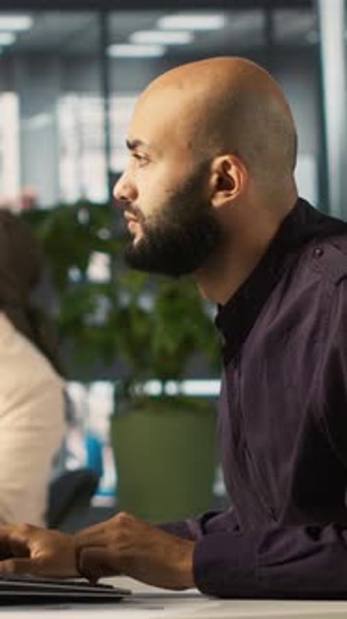 Vertical Video Man in Office Reviewing Financial Graphs Analyzing KPIs