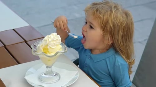Child enjoys ice cream sundae outdoors