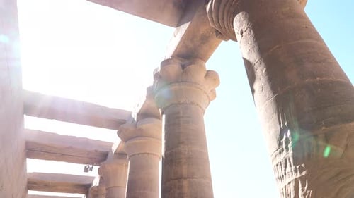 Panning shot of Ancient egyptian temple columns on a sunny day