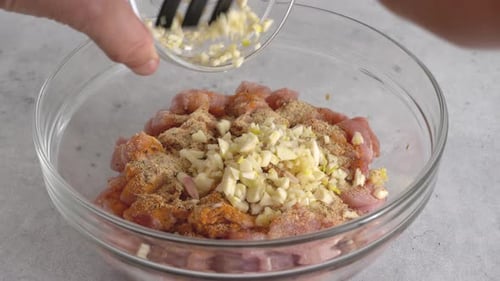 Raw Meat Seasoned in Clear Bowl with Garlic