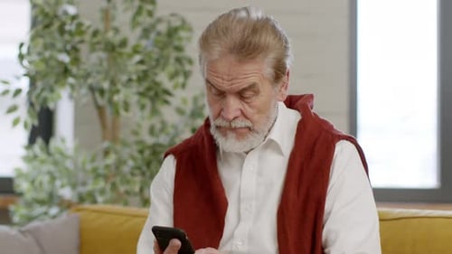 Positive Senior Bearded Man Looking at Calling Cellphone and Answering Tracking Shot Slow Motion