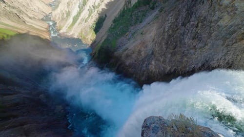 Looking Over Huge Waterfall Flowing Through Yellowstone River Valley