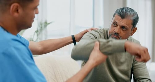 Caregiver Assists Senior Man With Physical Therapy Exercises
